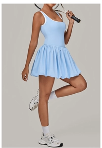 Detail of light blue tennis dress featuring backless design and pleated athletic skirt