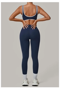 Back view of navy yoga set with white trim detail on a high-elastic sports bra and leggings