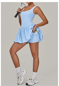 Detail view of light blue tennis dress featuring backless design and ball pocket on inner shorts