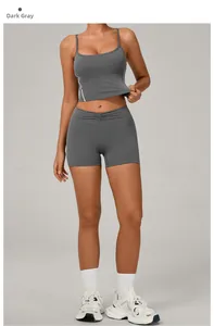 Detail of dark grey two-piece yoga set with high-waist ruched shorts and U-neck sports bra