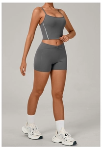 Detail of high-waisted yoga shorts and sports bra with contrast white side stripes