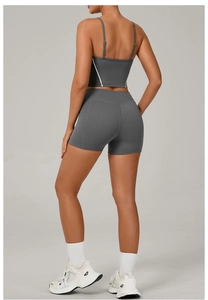 Rear view of dark grey yoga set with spaghetti strap sports bra and high waist shorts