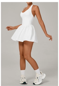 Macro detail of white pleated tennis dress with halter neck and backless athletic design