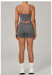 Rear view of grey yoga set with slim-fit high waist shorts and backless sports bra