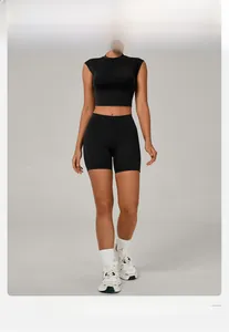 Detail of black seamless short sleeve yoga top and high waist shorts on a professional model