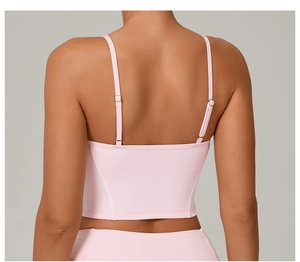 Detail of adjustable double straps on light pink yoga bra with cross back design