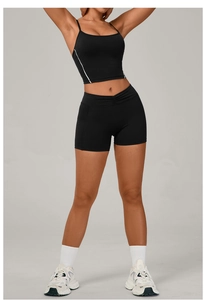 Detail of high-waist V-cut black sports shorts and racerback tank top with white stripes