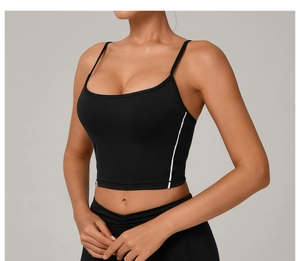 Detail view of black cropped yoga vest featuring white side stripes and slim straps