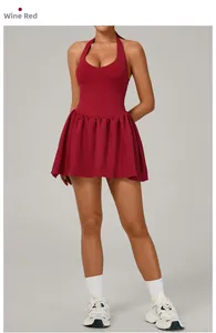 Detail of a wine red sports tennis dress featuring a halter neck design and pleated skirt