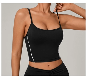 Detail of black sports bra with adjustable double straps and white contrast stitching