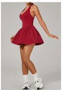 Detail of red backless tennis dress with pleated skirt and halter neck design