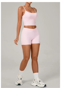 Pink yoga set featuring ribbed high-waist shorts and U-neck sports tank top for women