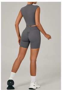 Detail view of high-waist scrunch butt shorts and back of gray cropped fitness top