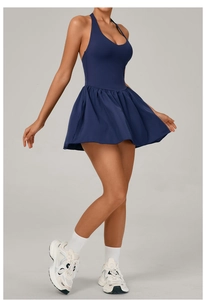 Detail view of dark blue halter neck tennis dress with pleated skirt for active sports