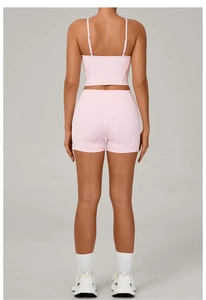 Close-up of light pink high-waist yoga shorts with breathable fabric for athletic wear