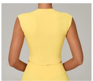 Rear view of tight-fitting yellow athletic yoga top featuring quick-dry fabric details