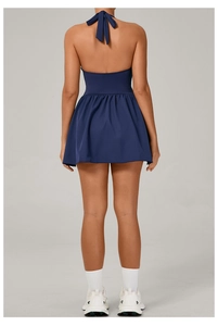 Deep blue halter backless tennis dress with tie-neck detail and pleated athletic skirt
