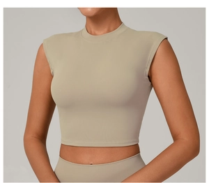 Detail shot of beige slim-fit mock neck yoga top showing elastic fabric and seam quality