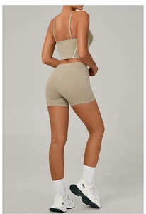 Detail view of khaki yoga set showing side streamline seams and high-waisted lifting shorts