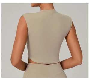 Detail of slim fit yoga top with high neckline and racerback in beige stretch fabric