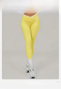 Detail view of yellow high-waisted yoga leggings with a stylish V-cross overlapping waistband