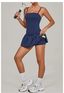 Detail of navy tennis dress featuring pleated skirt and convenient ball pocket
