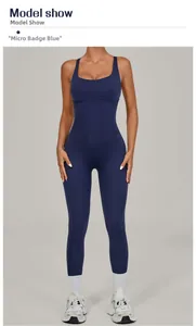 Detail of model wearing a Navy Blue slim fit yoga jumpsuit with adjustable straps