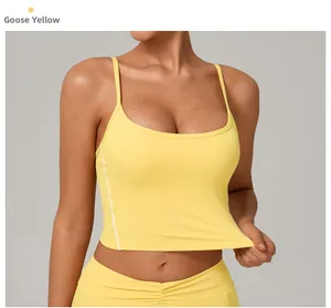 Detail view of goose yellow yoga sports bra with thin double straps and side stitching