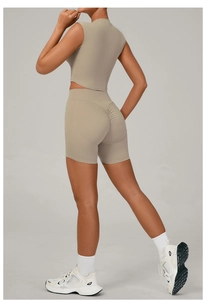 Detail view of khaki yoga set showing side profile of slim fit top and high waist shorts