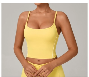 Detail view of yellow yoga tank top with thin shoulder straps and white side stripes