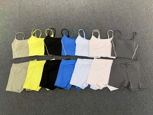 Flat lay of high elastic yoga sets featuring V-waist shorts and strappy tops in seven colors