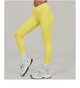 Close-up of high-waisted yoga leggings with contrast white crossover waistband design
