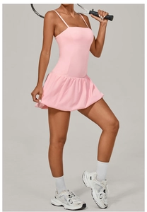 Close-up of pink pleated hem on athletic dress for tennis and golf with moisture-wicking fabric
