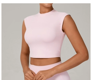 Close-up of pink slim fit yoga t-shirt with crew neck and moisture-wicking fabric