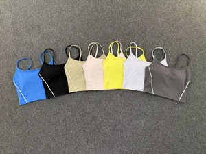 Detailed flat lay of sports bras in seven colors showing thin straps and side stripe design