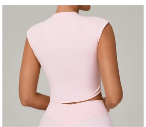 Rear view of a model in a light pink slim fit dry-tech athletic top for fitness