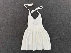 Detail view of white halter tennis dress with built-in pads and open back design