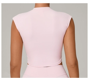 Rear view of a slim fit pink cropped yoga top showing athletic cut and quick-dry fabric