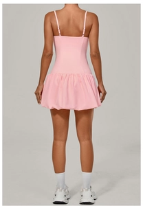 Rear view of pink athletic golf dress with ruffled hem and adjustable straps