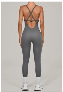 Detail view of the criss-cross back straps and adjustable silver buckle on yoga bodysuit