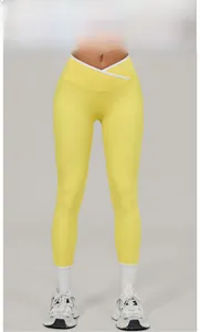 Detail view of Goose Yellow yoga pants with V-shaped crossover high waistband and white seams