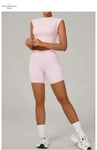 Detail of cherry pink seamless yoga set featuring racerback tank and high waist gym shorts