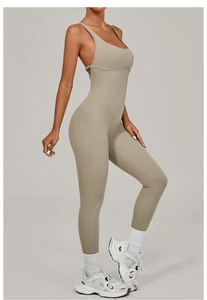 Detail of taupe yoga bodysuit with adjustable straps and ribbed waist contouring seams