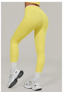 Detailed side view of high-waist yellow yoga leggings showing body shaping and butt-lift effect