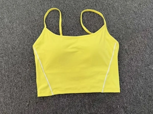 Detail of adjustable double straps on yellow high-stretch yoga vest with white side stripes