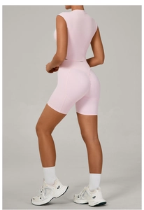 Rear view of pink tight yoga set showing scrunch butt leggings and cropped short sleeve top