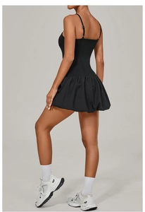 Detail view of the black sleeveless tennis dress featuring a pleated bubble hem and shorts