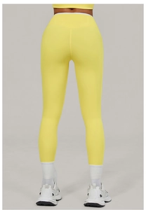 Rear view of bright yellow high waist yoga pants showing professional lift and sculpt design