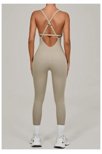 Detail of cross-back adjustable straps and open back design on the beige yoga jumpsuit