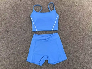 Sky blue yoga set featuring a cross-back tank top and high-waisted ruched sports shorts